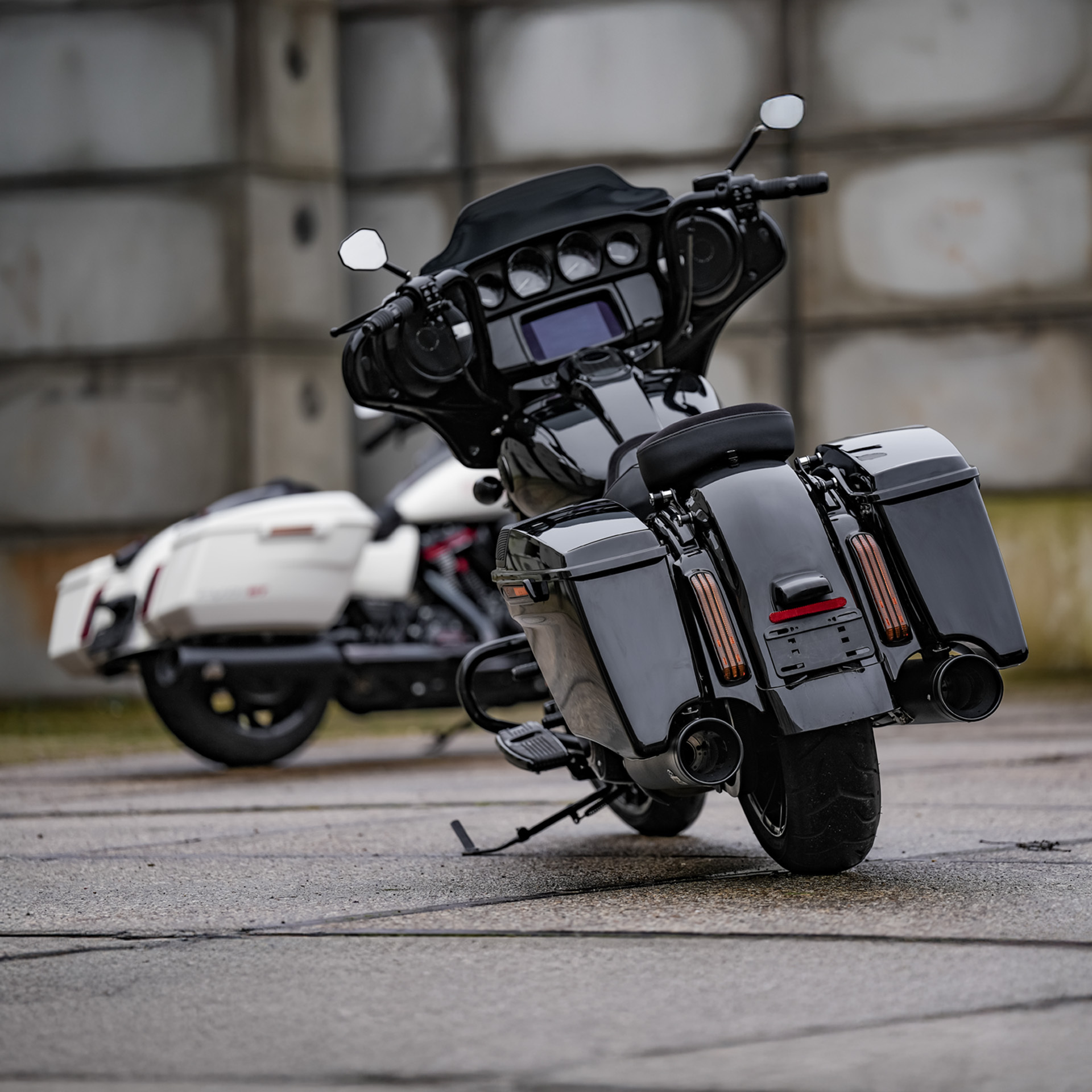 Rear view of two Harley's, one in the distance